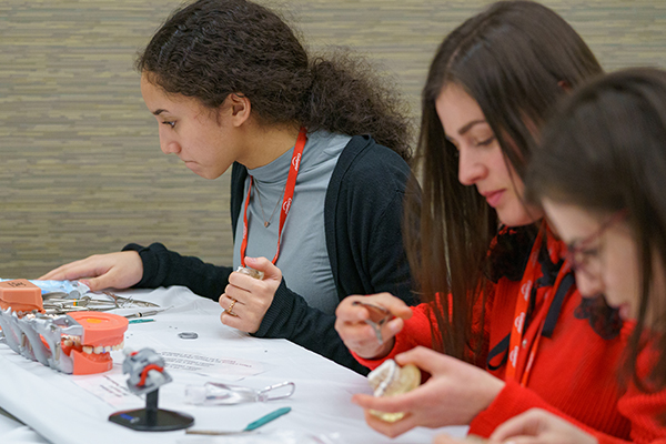 three women participating in a hands-on course at Yankee Dental Congress